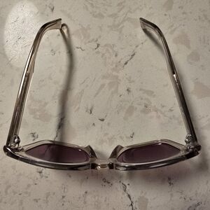 Stylish Maui Jim Polarized Transparent Sunglasses with Purple Lenses.